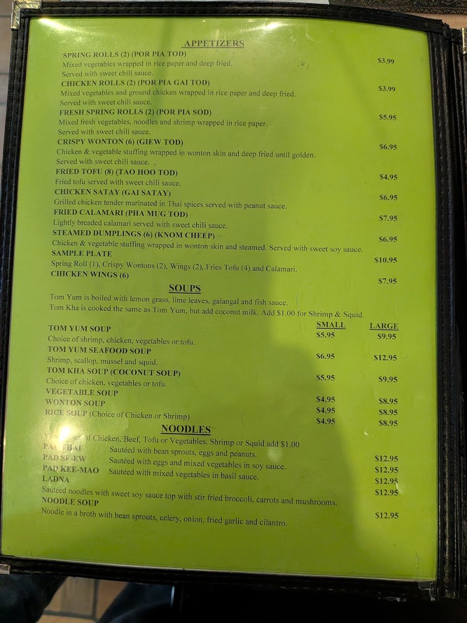 Thai menu featuring curries, stir-fries, and noodles.